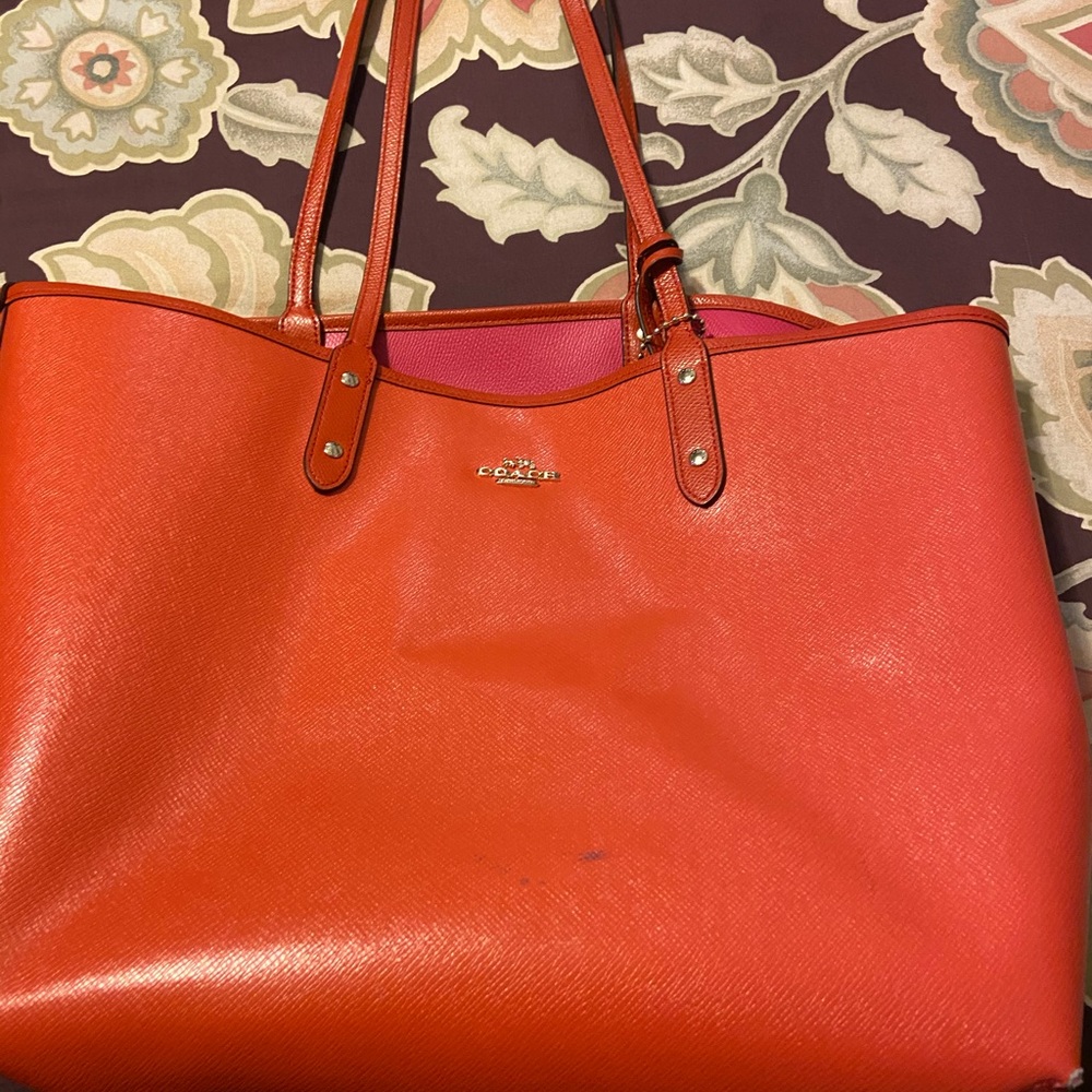 Red coach tote that can be reversed to pink.